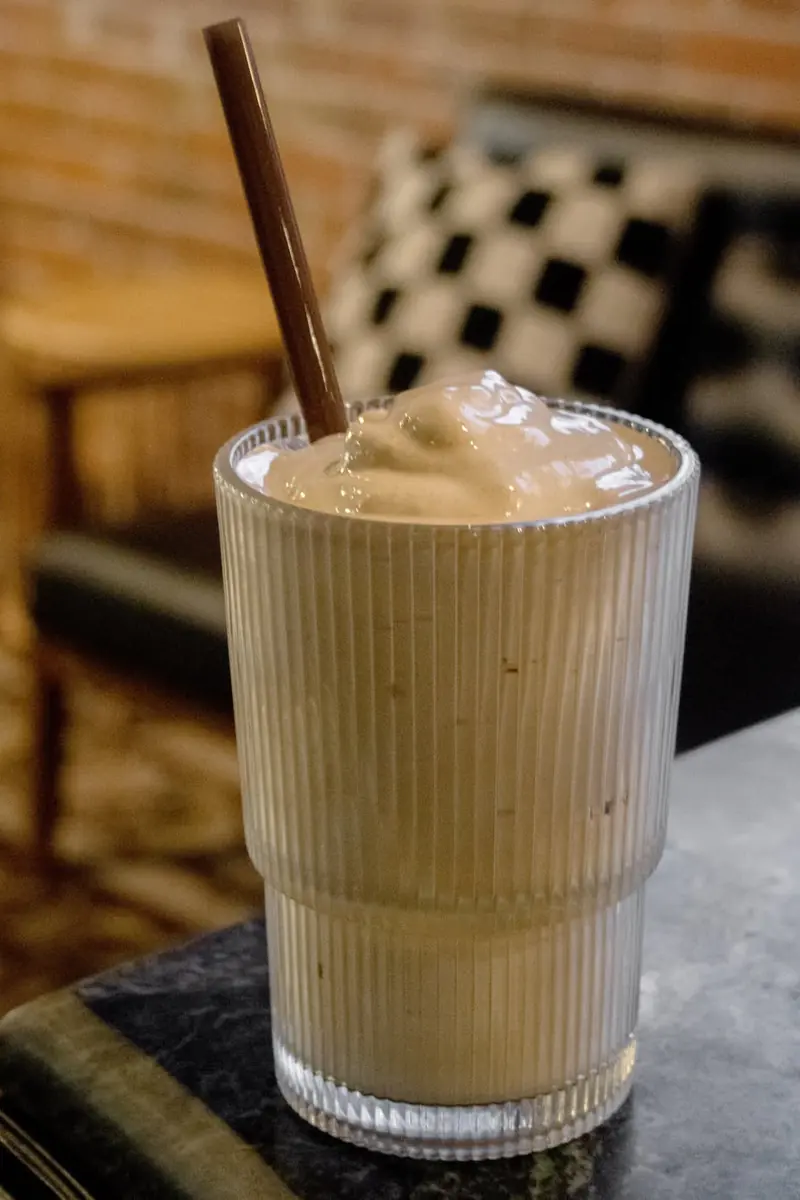 Brown Sugar Freddo, frothy whipped espresso in a ribbed glass
