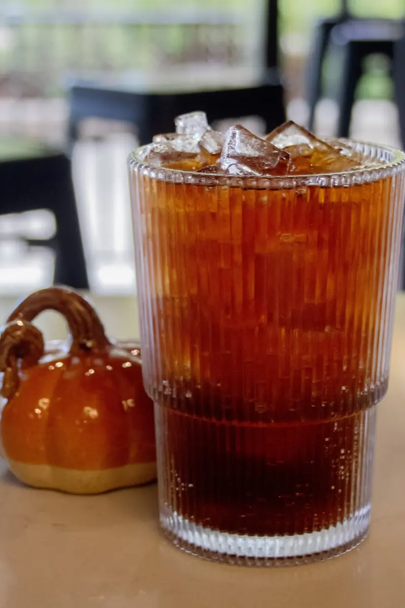 Iced Orange Clove Cold Brew Tonic in a ribbed glass